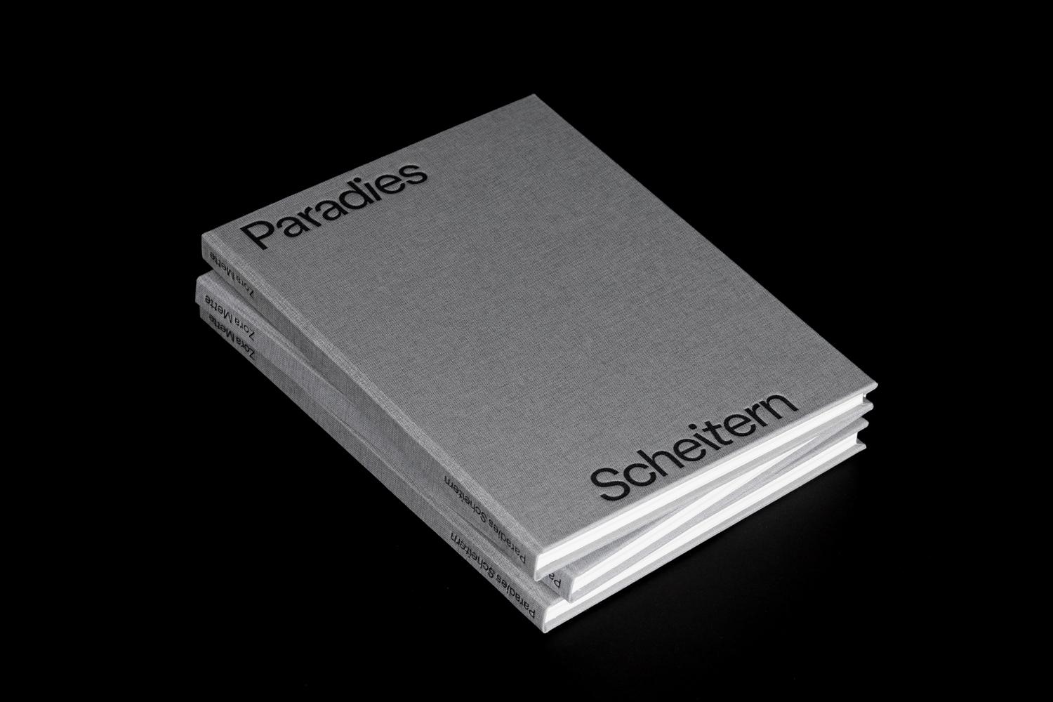 Graues Buch mit schwarzer Schrift: Titel Paradies Scheitern